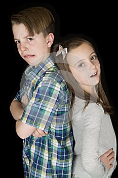 Crazy facial expression portrait of young boy & girl black back