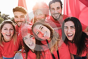 Crazy football fans having fun outside stadium for soccer match - Focus on center girl face