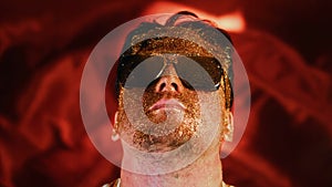 Crazy fun positive face man in gold glitter. Comical photo shake head funny person. Expression emotion guy in sunglasses