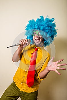 Crazy funny young man with blue wig