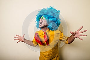 Crazy funny young man with blue wig