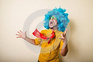 Crazy funny young man with blue wig