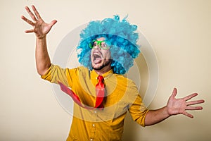 Crazy funny young man with blue wig