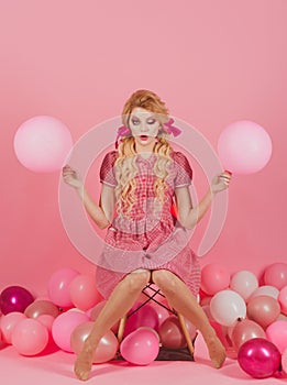 Crazy girl on halloween. Creative idea. retro girl with makeup and curly hair in party balloons. vintage fashion woman