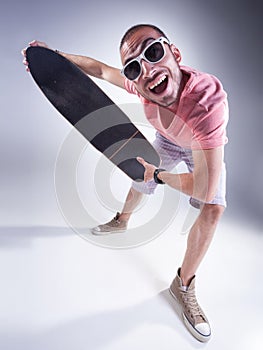 Crazy guy with a skateboard making funny faces