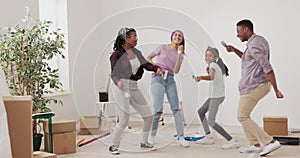 Crazy happy family painting the walls with white paint with brushes, they dance in the