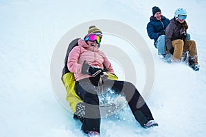 Crazy happy friends having fun with sledding on snow high mountains - Young people making luge competition at white week vacation