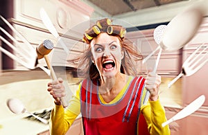 Crazy housewife in apron cooking, cookware flying