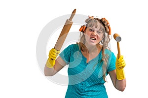 Crazy housewife with kitchen roller and meat hammer