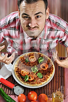 Crazy hungry man eating pizza