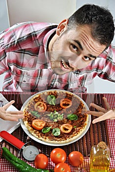 Crazy hungry man eating pizza