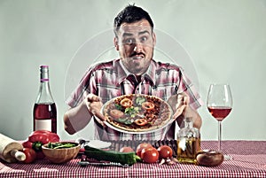 Crazy hungry man eating pizza