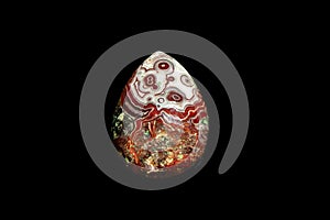Crazy lace agate pear cabochon. Black background.