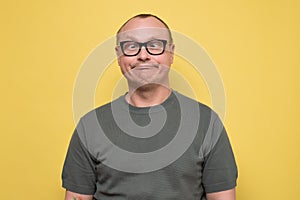 Crazy looking man in glasses making funny faces squinting eyes