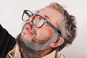 Crazy looking old man with grey beard with nerd big glasses