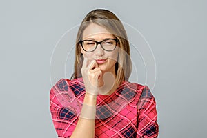 Crazy looking sly woman in glasses isolated