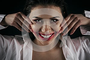 Crazy-looking woman smearing lipstick