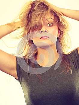 Crazy, mad blonde woman with messy hair