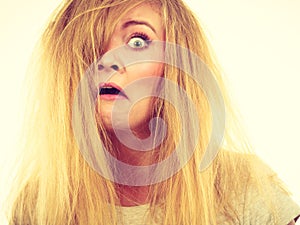 Crazy, mad blonde woman with messy hair