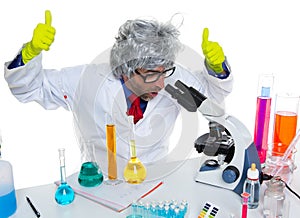 Crazy mad nerd scientist at laboratory microscope