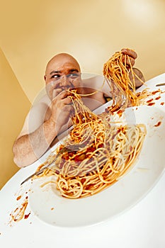 Crazy man eating plate of spaghetti