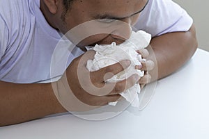 Crazy man eating tissue paper