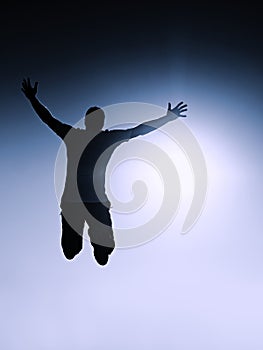 Crazy man is flying over Sun on blue sky background.