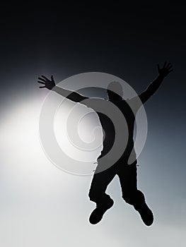 Crazy man is flying over Sun on blue sky background.