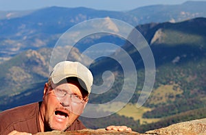 Crazy Man Hanging on the side of a Mountain