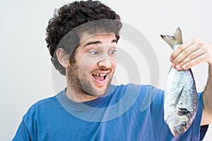 Crazy man holding a fish