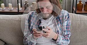 Crazy man listening to music using mobile phone and headphones