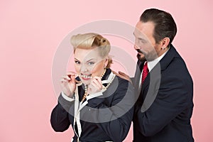 Crazy managers in suits and perls. Blonde and boss in red tie have fun in studio with perls