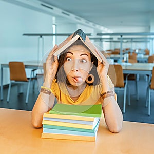 nerd girl buried in textbooks and teaches math to prepare for exams. Concept of a University and school library