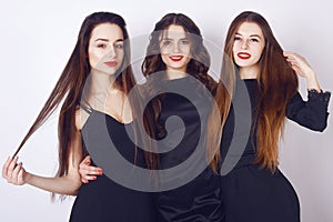 Crazy party time of three beautiful stylish women in elegant evening casual black dress celebrating , having fun, dancing