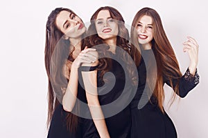 Crazy party time of three beautiful stylish women in elegant evening casual black dress celebrating , having fun, dancing