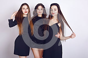 Crazy party time of three beautiful stylish women in elegant evening casual black dress celebrating , having fun, dancing