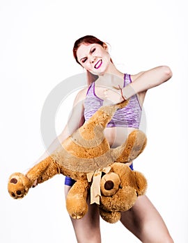 Crazy redhead young woman tears off a bears legs