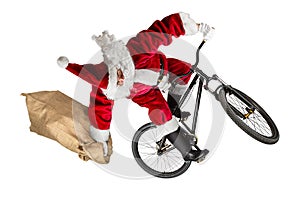 Crazy santa claus jump on dirt mountain bike with jute burlap ba