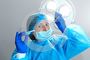 Crazy scary and funny doctors surgeons dentists in masks with gloves and coats scare and tease on camera. A nightmare patient.