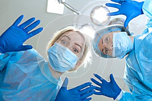 Crazy scary and funny doctors surgeons dentists in masks with gloves and coats scare and tease on camera. A nightmare patient.