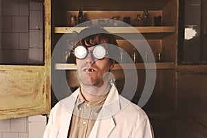 Crazy scientist with creepy face in his laboratory