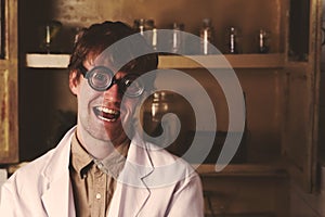 Crazy scientist smiles to the camera