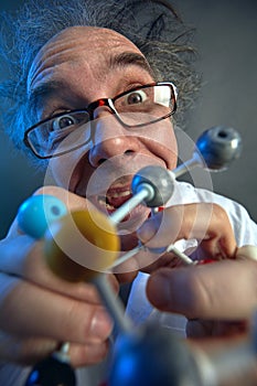 Crazy scientist with structure of model molecules
