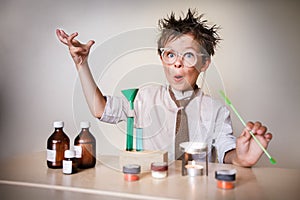 Crazy scientist. Young boy performing experiments