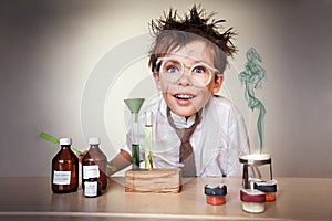 Crazy scientist. Young boy performing experiments photo