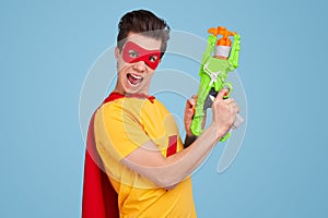 Crazy superhero with toy gun