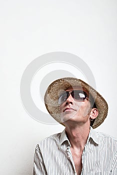 Crazy vacationer in straw hat and sunglasses dreaming photo