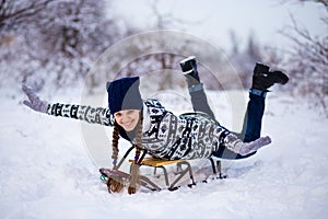 Crazy woman enjoy a sleigh ride. Woman sledding