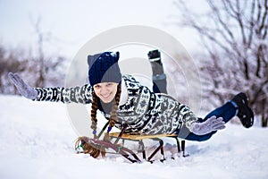 Crazy woman enjoy sleigh ride. Woman sledding. Funny woman play outdoors in snow. Outdoor fun for Christmas