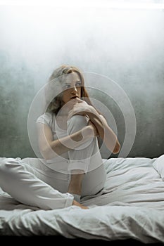 Crazy woman with pillow in bed, psychedelic